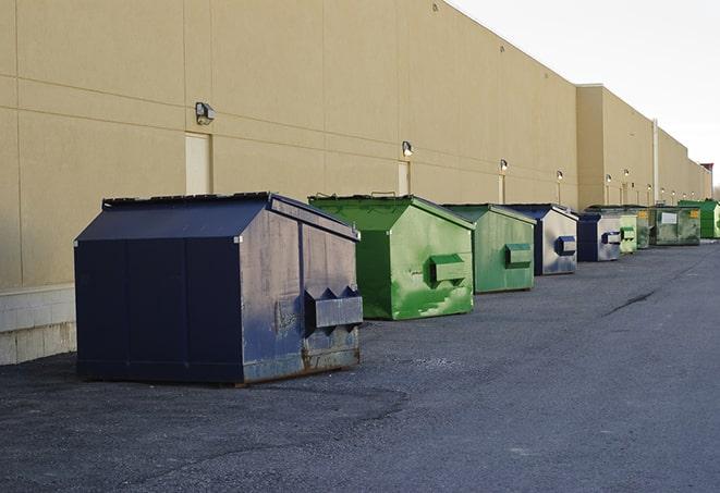 construction workers disposing of debris in large dumpsters in Los Angeles